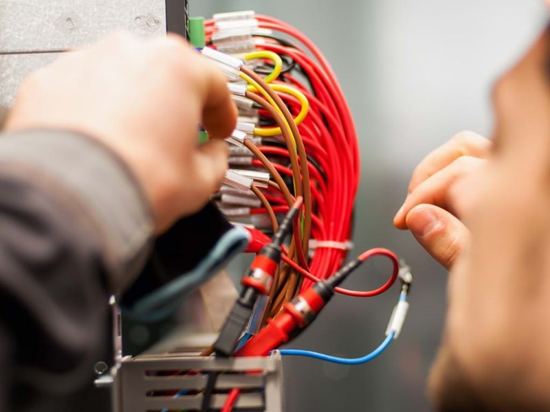 Electrician Engineer Tests Electrical Installations On Relay System